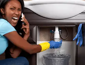 Emergency plumbing repair for a leaking sink drain under a bathroom vanity in Sacramento, CA