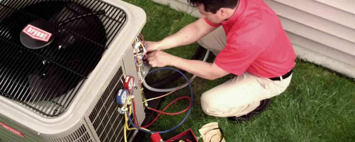 HVAC technician servicing an outdoor air conditioner unit in Sacramento, CA