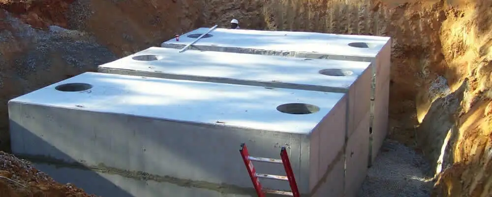 Septic tank installation site with a newly placed concrete tank in Sacramento, CA